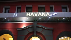 The exterior of HAVANA Resort with a prominent sign, arched entrance, and a well-lit facade. - Havana Resort (Antananarivo)