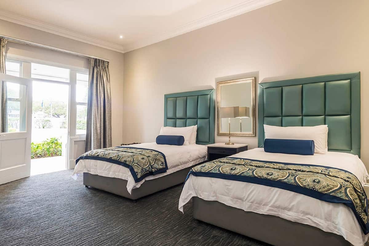 family room | in-room safe, desk, blackout curtains, iron/ironing board