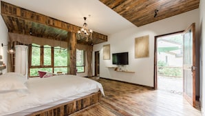 A bedroom with a wooden floor, a bed, a TV, and a large window. - Moganshan Jianqi Inn (Huzhou)