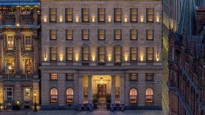 A large, multi-story building with a symmetrical facade, evenly spaced windows, and a central entrance with a canopy. - The Edinburgh Grand, a Luxury Collection Hotel, Edinburgh (Edinburgh)