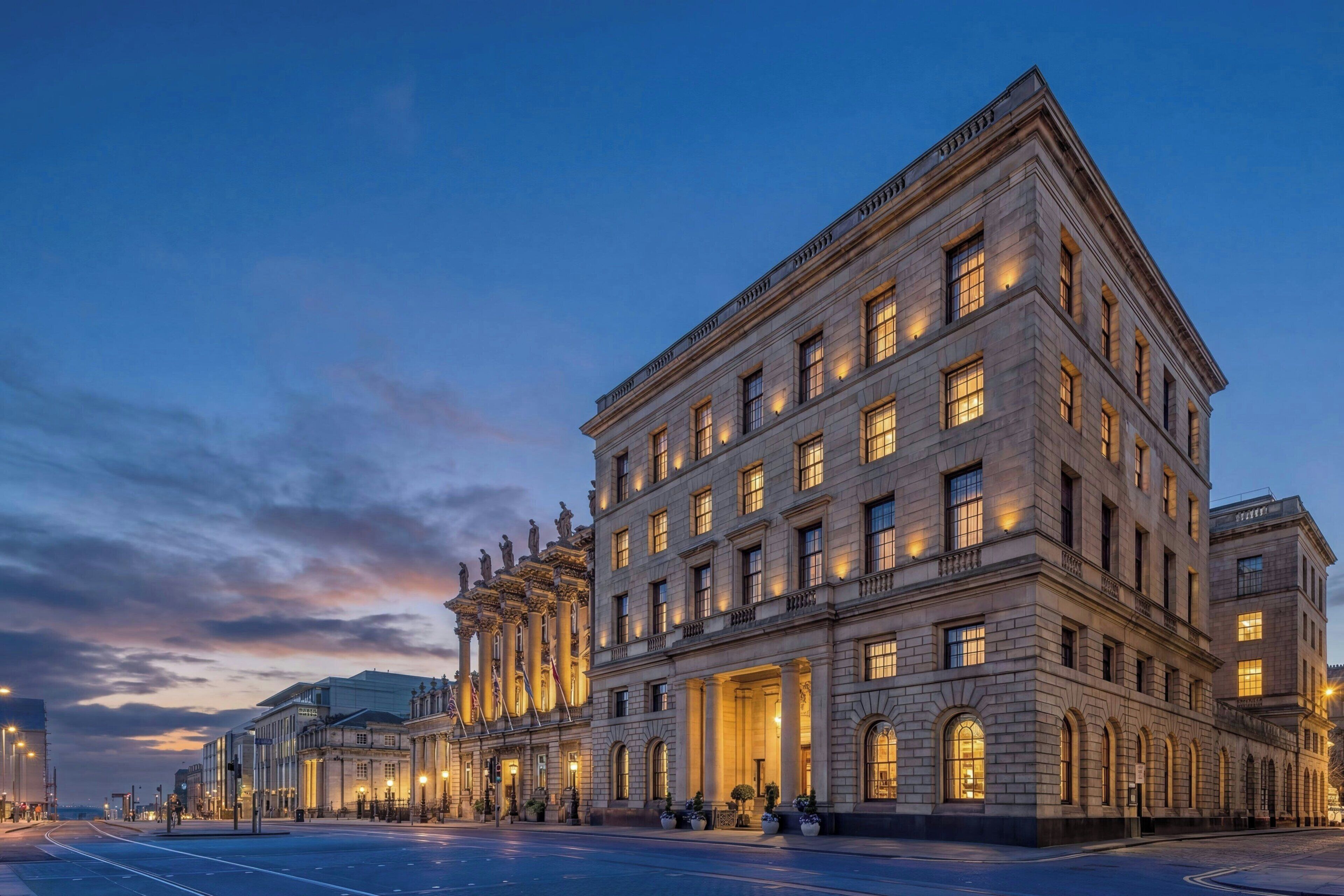 A large, historic building with multiple floors, large windows, and a prominent entrance.