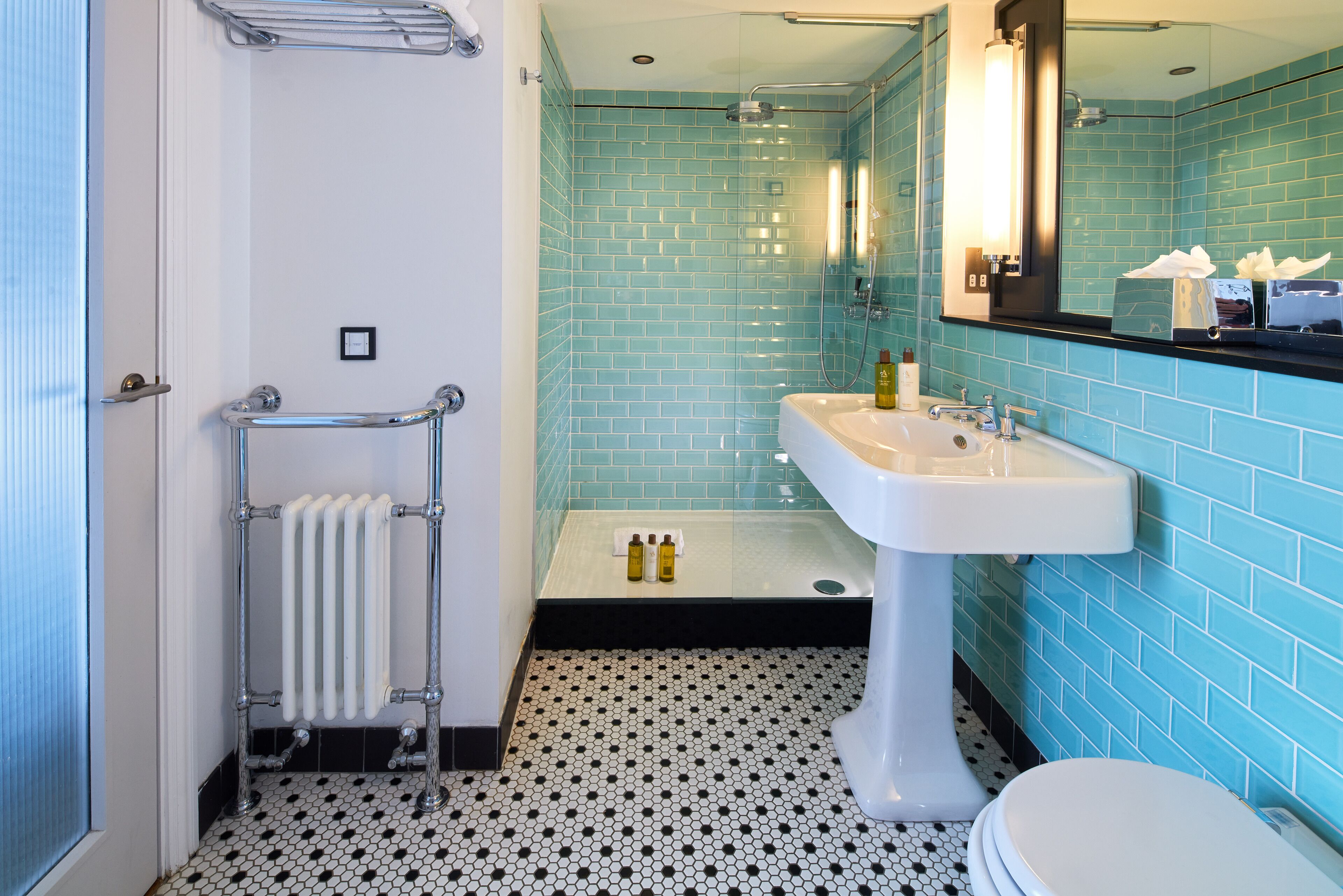 A bathroom with a white sink, a toilet, and a shower area.