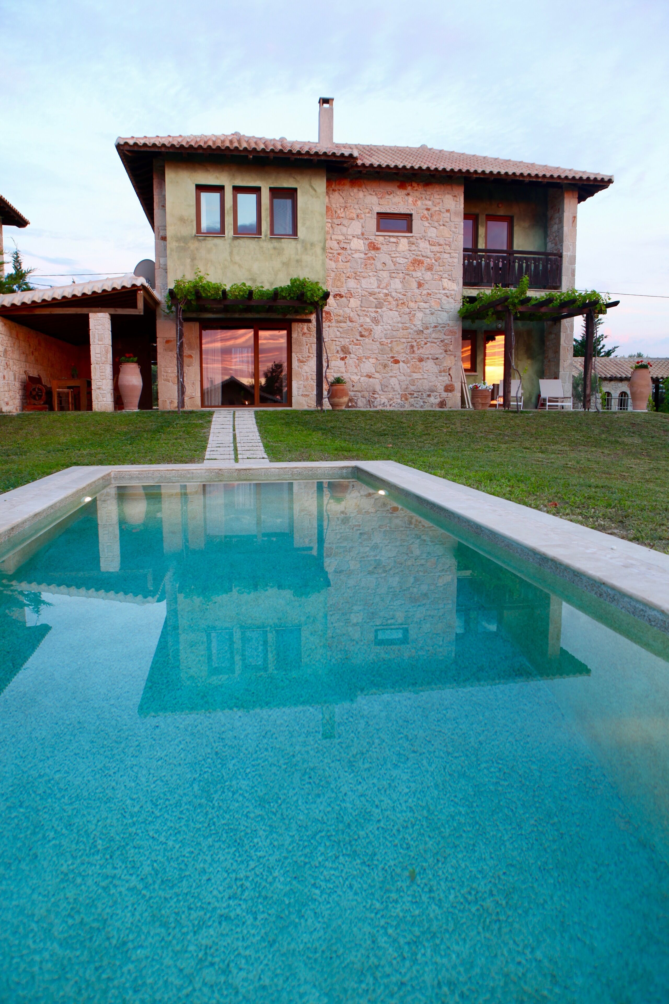 A house with a swimming pool in front.