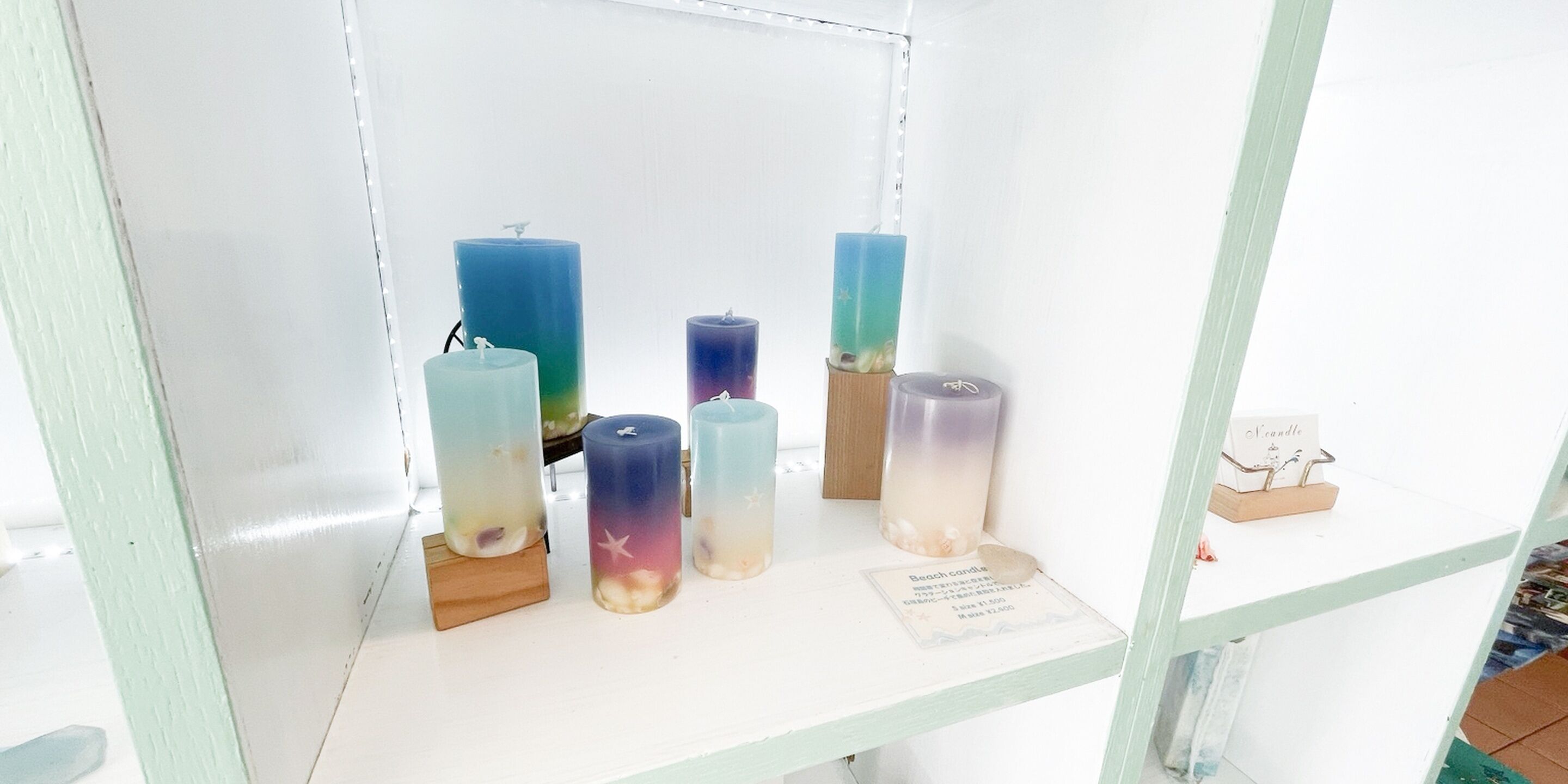 A display of candles with a label indicating 'Beach candle'.