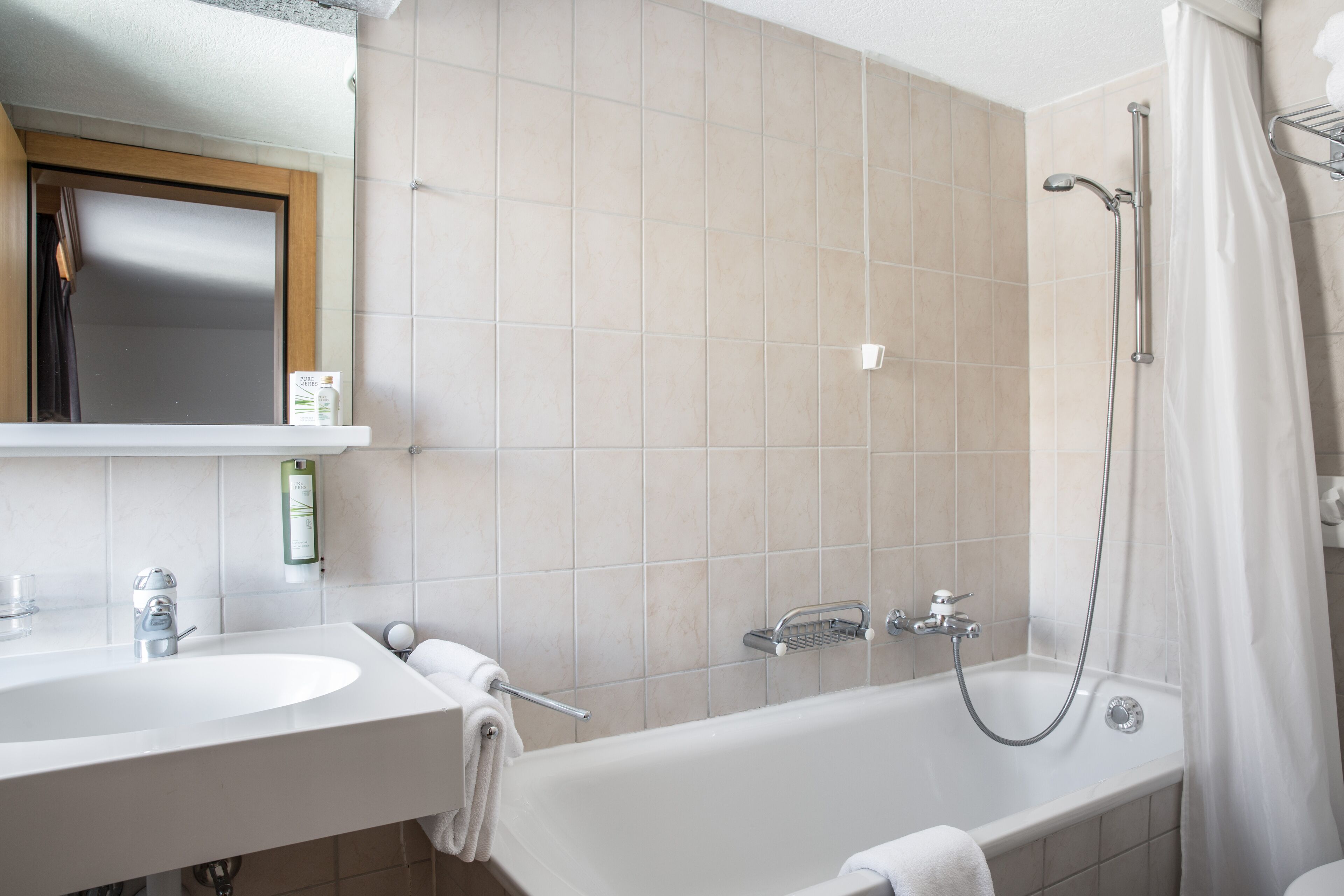 A bathroom with a bathtub, a sink, and a shower.