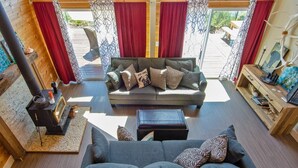 A cozy living room with a sofa, a coffee table, and a fireplace. - Island house located on Stretch Island close to Fair Harbor (Grapeview)