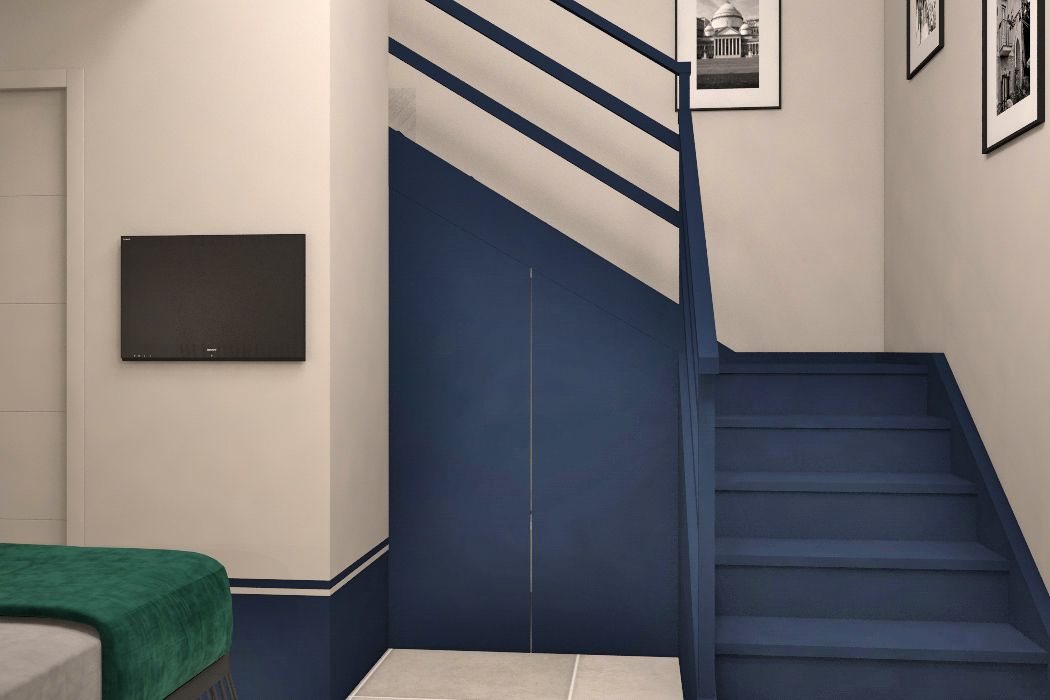 A staircase with blue steps and white walls, a flat-screen TV mounted on the wall, and framed pictures on the wall.