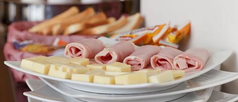 A buffet setup with various food items and utensils.