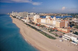 An aerial view of a coastal city with a long beachfront, high-rise hotels, and a marina. - Hollywood Beach Resort-renovated Studio Nice Views (Hollywood)