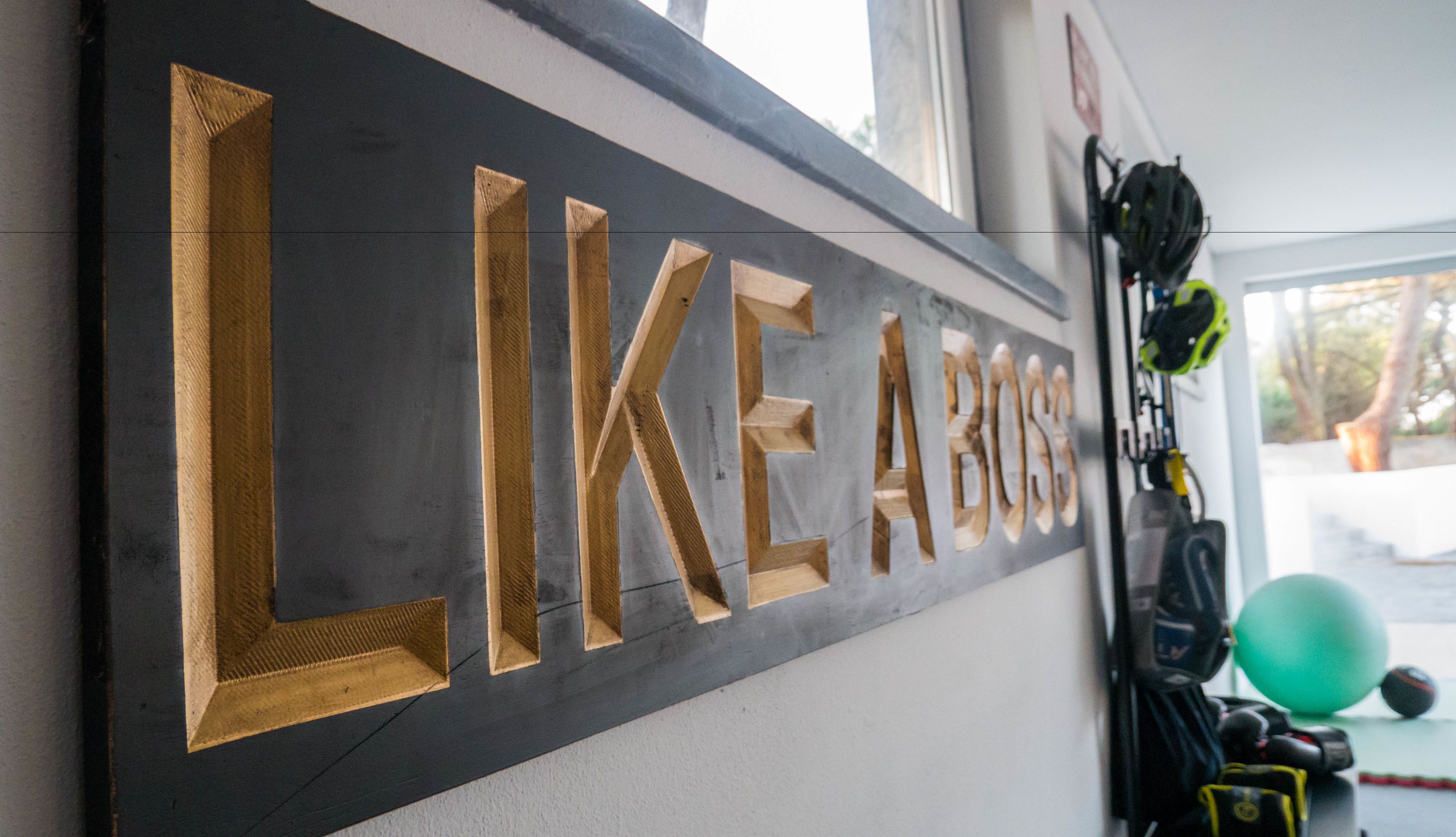 A wall with the words "LIKE A BOSS" in large, gold letters.