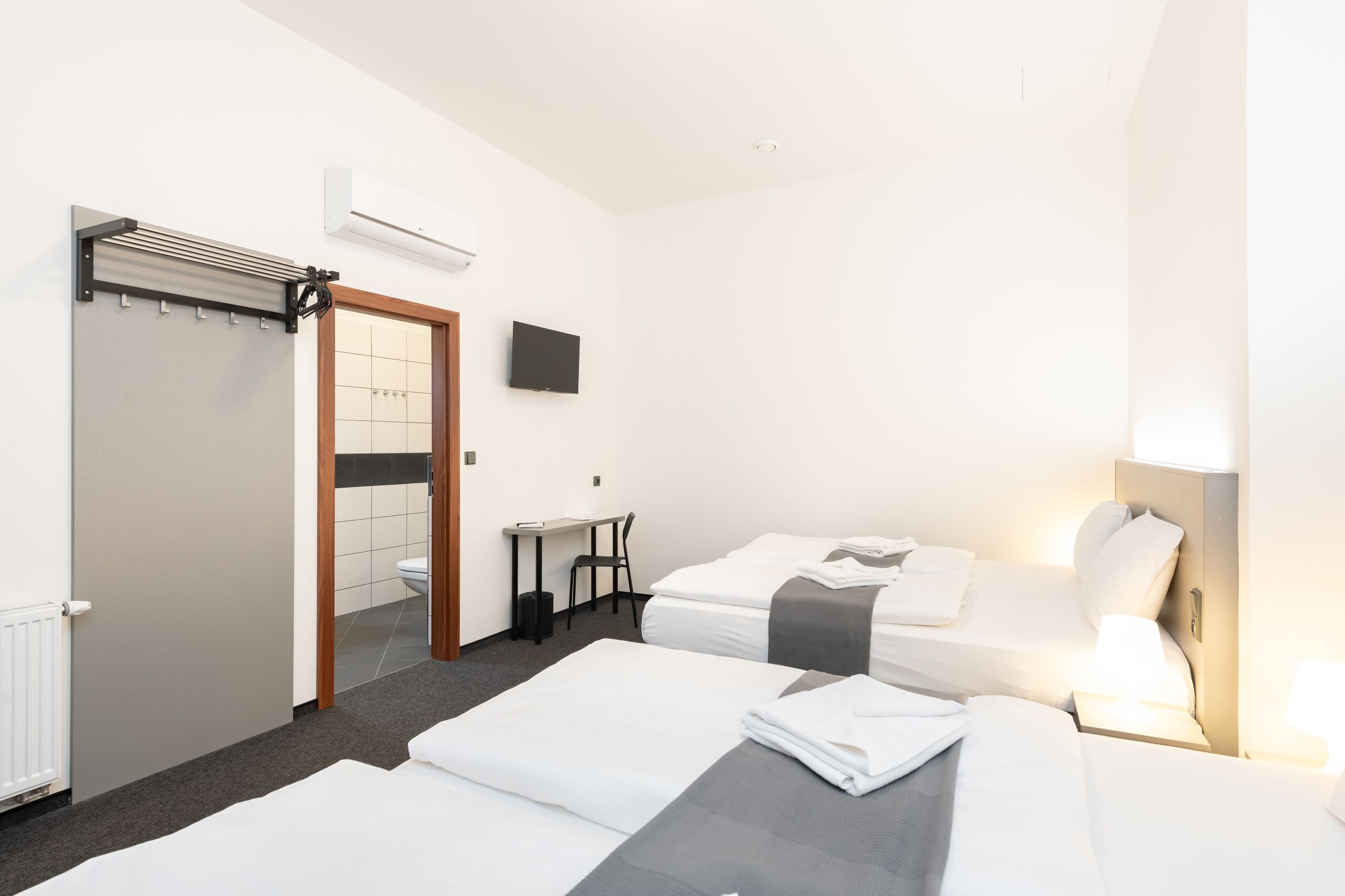 Hypo-allergenic bedding, desk, laptop workspace, blackout curtains