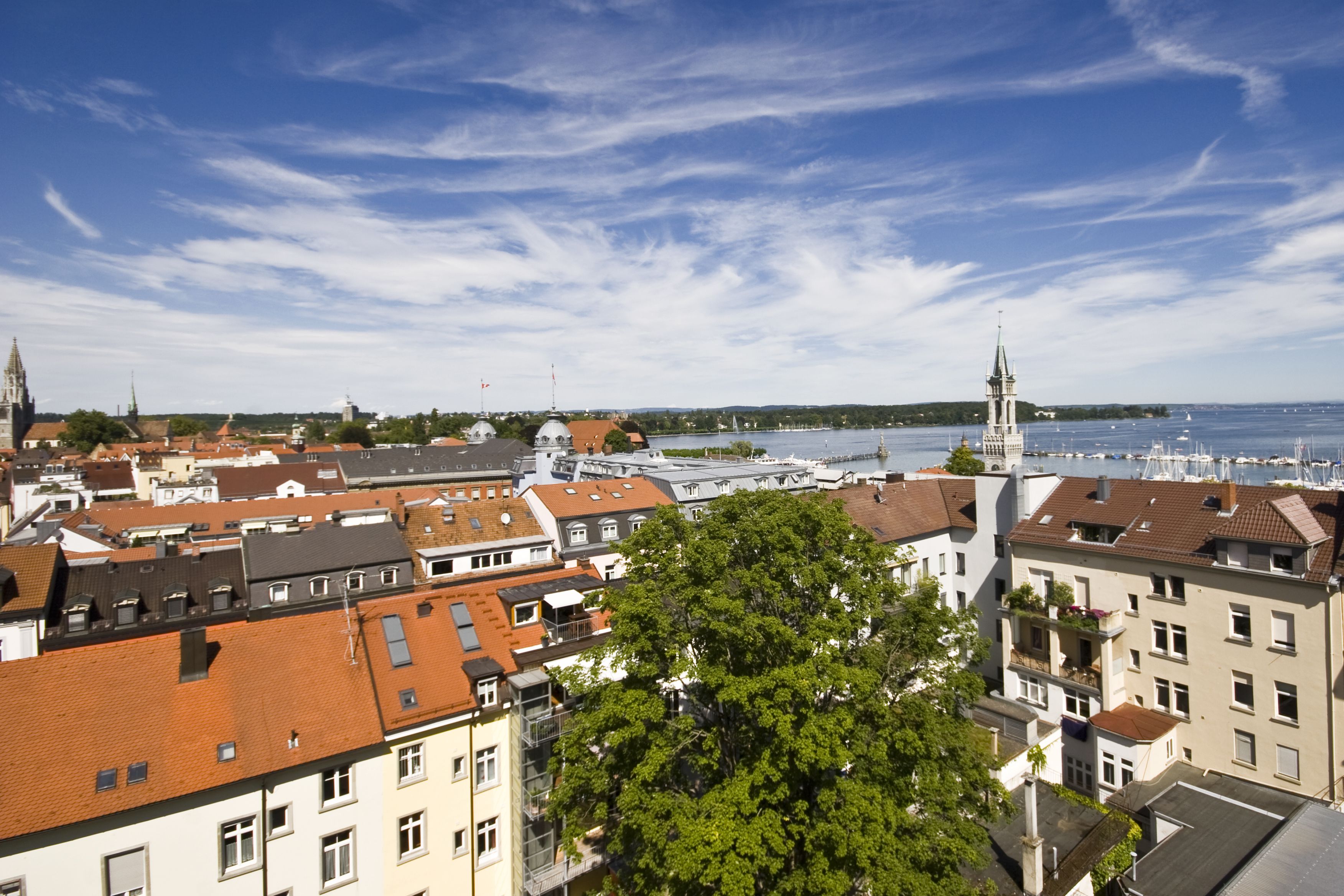 A cityscape with buildings, a river, and a tower.