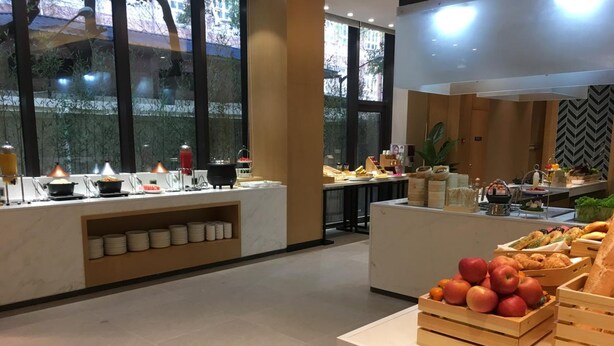 A modern breakfast buffet with various food items and a fruit display. - Fairfield by Marriott Shanghai Jingan (Shanghai)