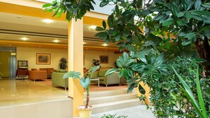 A spacious lobby with a modern design, featuring a seating area with sofas and a staircase leading to upper floors. - Bankya Palace (Sofia)