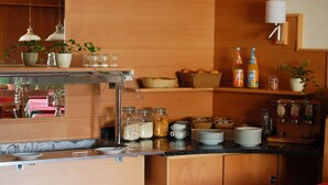 A breakfast bar with various food items, including jars of spreads, baskets of fruits, and condiments. - Hotel Spitzenpfeil (Michelau)