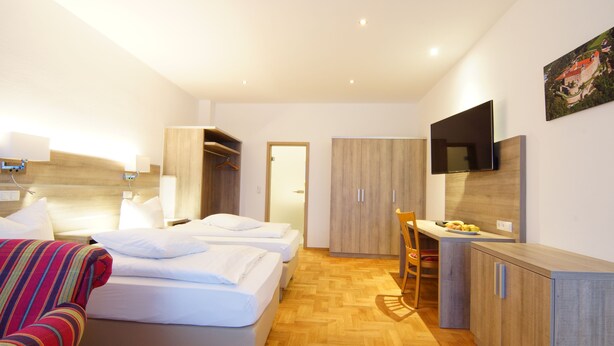 A hotel room with a bed, a desk, and a TV. - Hotel Spitzenpfeil (Michelau)