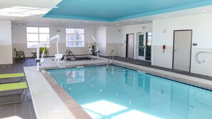 An indoor swimming pool with clear water, a changing room, and a door marked "EXIT". - Hampton Inn & Suites Lafayette Medical Center, CO (Lafayette)