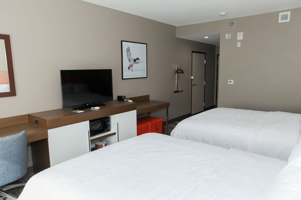 Luxe beddengoed, donzen dekbedden, een bureau, verduisterende gordijnen