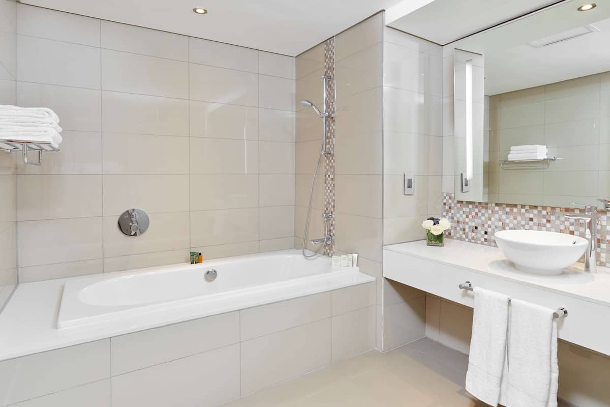 junior suite, 1 king bed | bathroom | separate bathtub and shower, deep-soaking bathtub, free toiletries