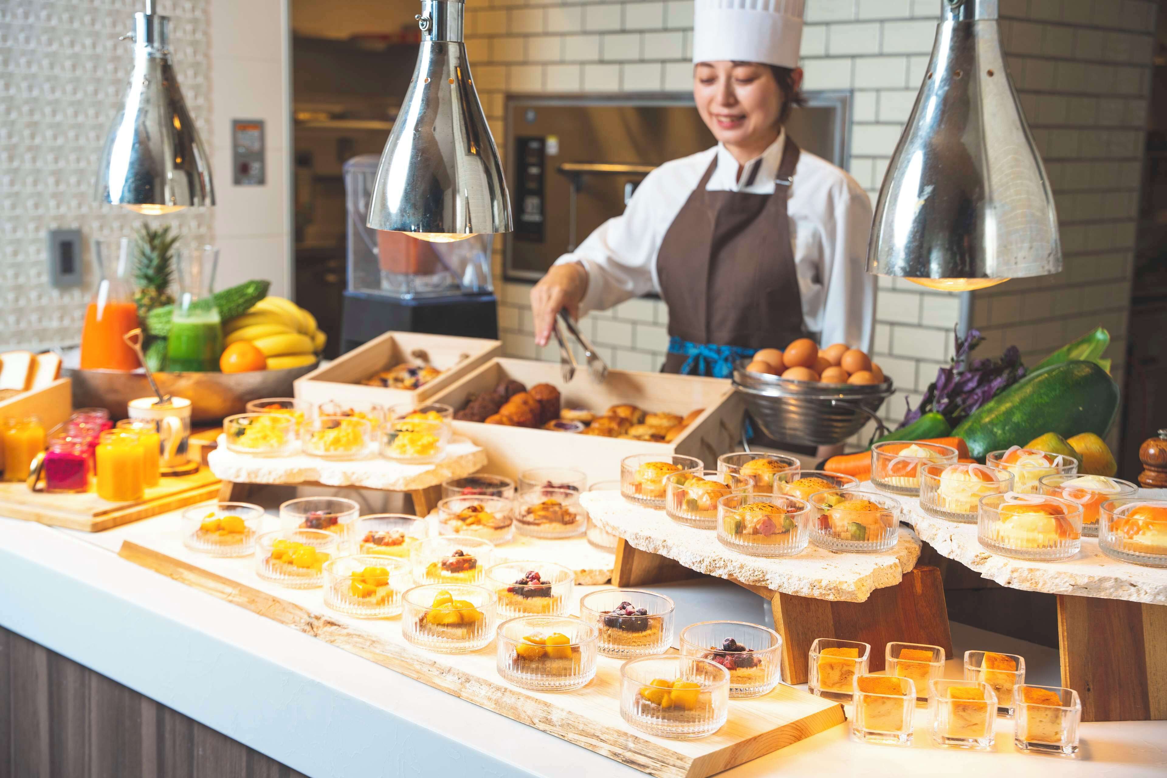 A buffet with various desserts and fruits.