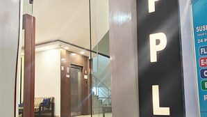 A hotel entrance with a glass door, a staircase leading up, and a sign reading "APPLE VILLA". - Hotel Apple Villa @ Paharganj (New Delhi)