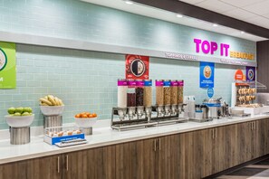 A breakfast buffet with various food options and a sign reading "TOP IT BREAKFAST". - Tru by Hilton Madison West, WI (Madison)
