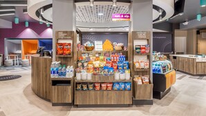 A snack kiosk with a variety of packaged snacks and beverages. - Tru by Hilton Madison West, WI (Madison)