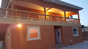 A two-story building with a balcony, a door, and a window. - Ri'Biero's Holiday Apartments (Crown Point)