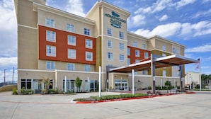 A hotel with a modern design, featuring a prominent sign for Homewood Suites by Hilton. - Homewood Suites by Hilton Conroe (Conroe)