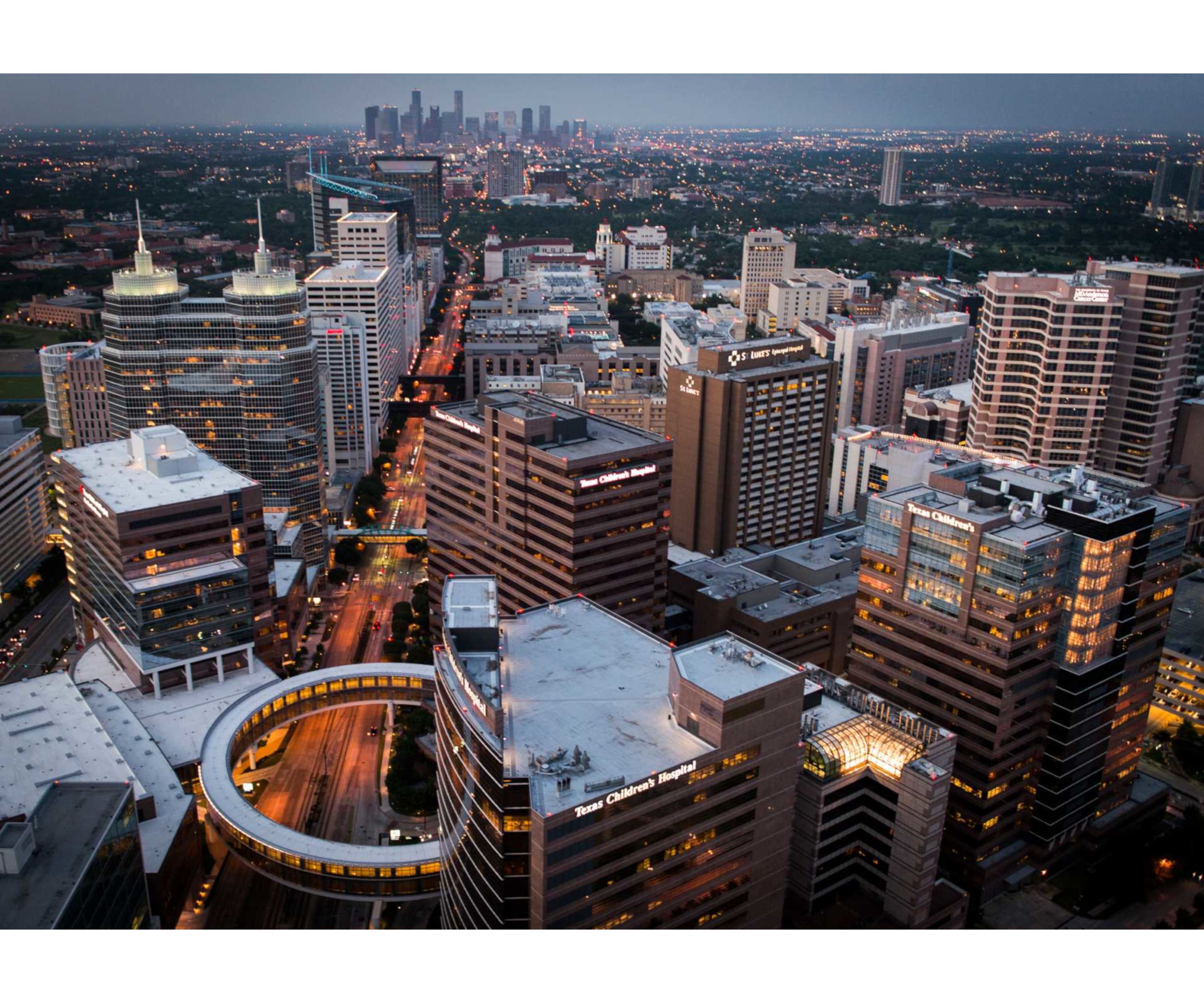 A cityscape with high-rise buildings, including a hospital and a children's hospital.
