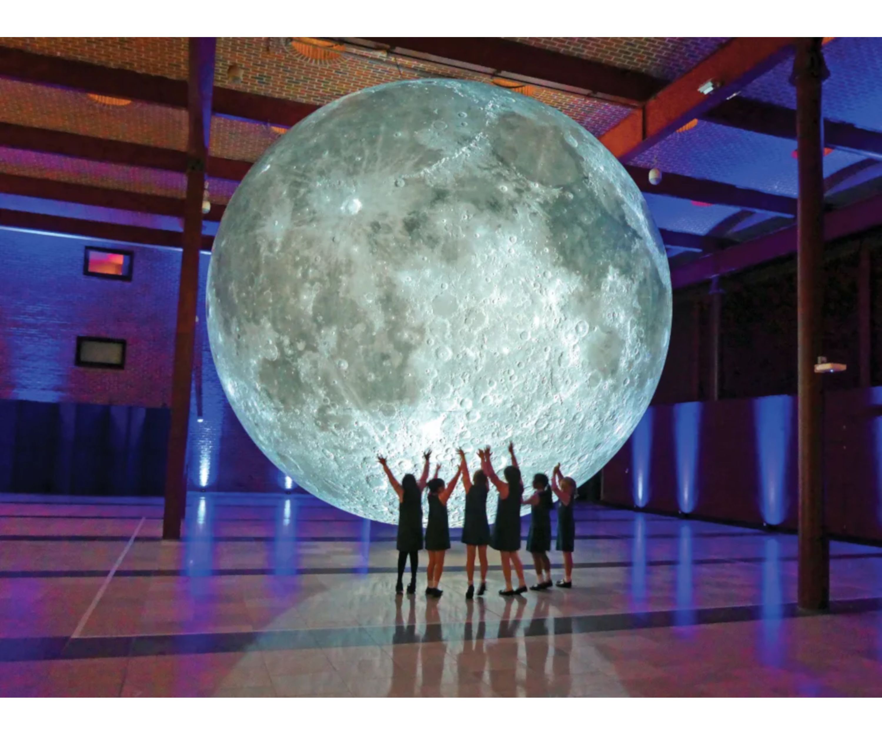 A large indoor space with a prominent spherical moon-like structure.