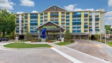 A multi-story hotel with a central entrance, balconies, and a sign reading "Margaritaville Resort".