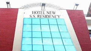 The exterior of Hotel New S.S. Residency with a prominent sign and a grid-like window pattern. - Hotel New SS Residency (Amritsar)
