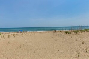 Relax by the ocean with a beach umbrella and scenic views.