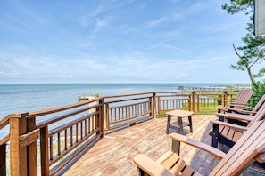 A wooden deck with a railing overlooking a body of water. - Grandview | Luxury Waterfront Sunset Views w/ Long Pier & Dock, Screened Porch, Kayaks + Pets (Chincoteague Island)