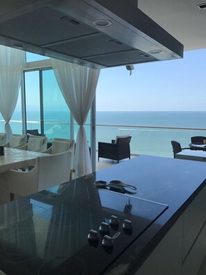 Enjoy meals in the kitchen with a stove and dining area overlooking the ocean.