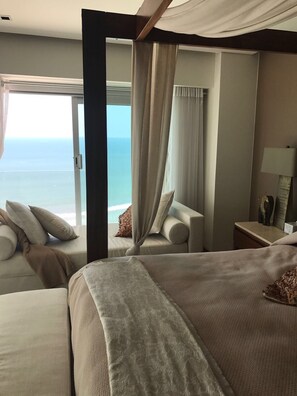 Relax in comfort with a large bed and ocean views from the spacious seating area.