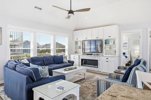 A modern living room with a sofa, coffee table, and TV.