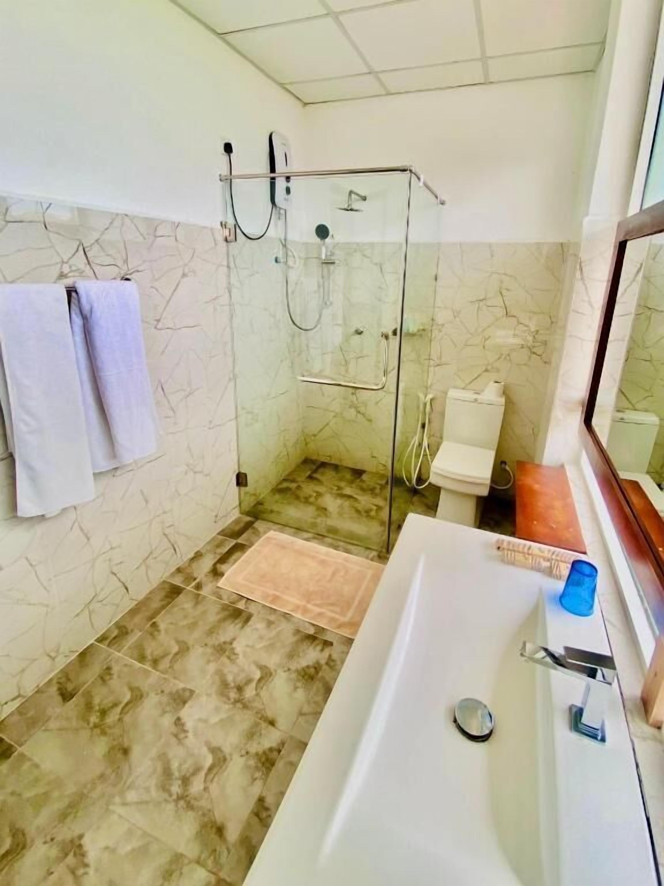 Shower, rainfall showerhead, designer toiletries, hair dryer