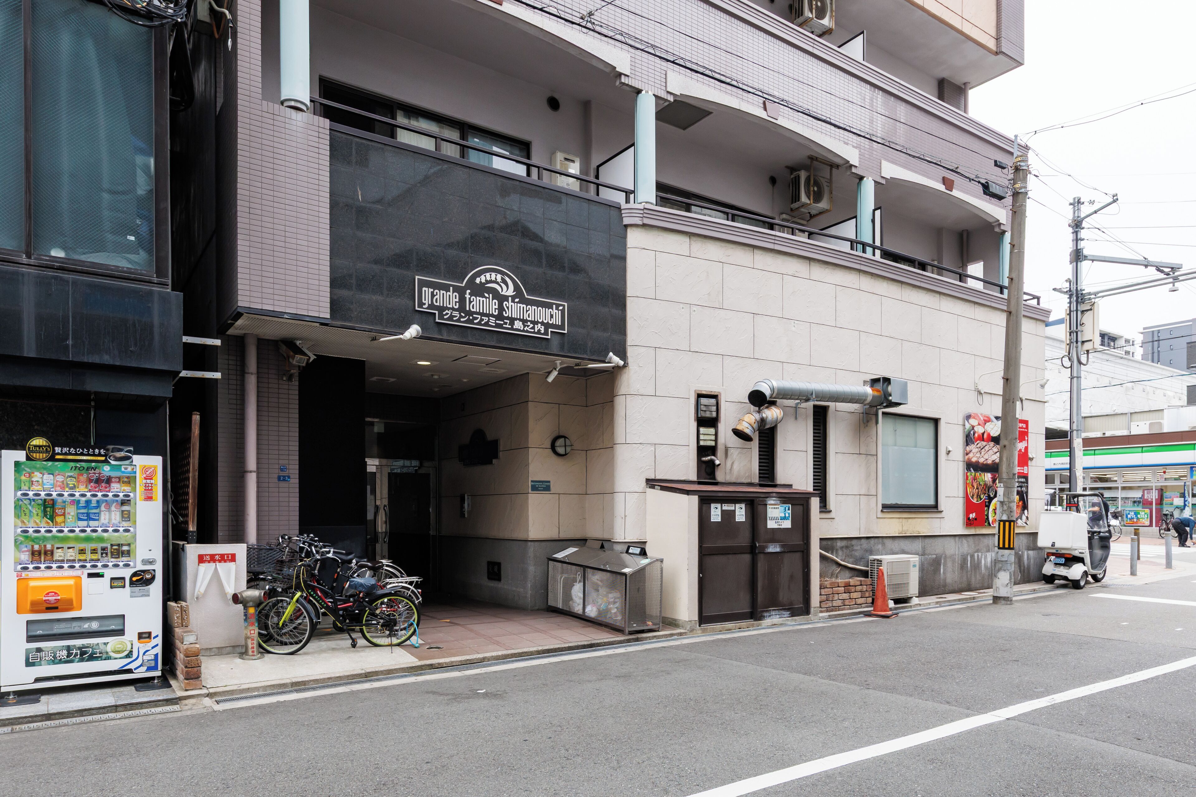 A commercial building with a storefront, vending machine, and bicycles parked outside.