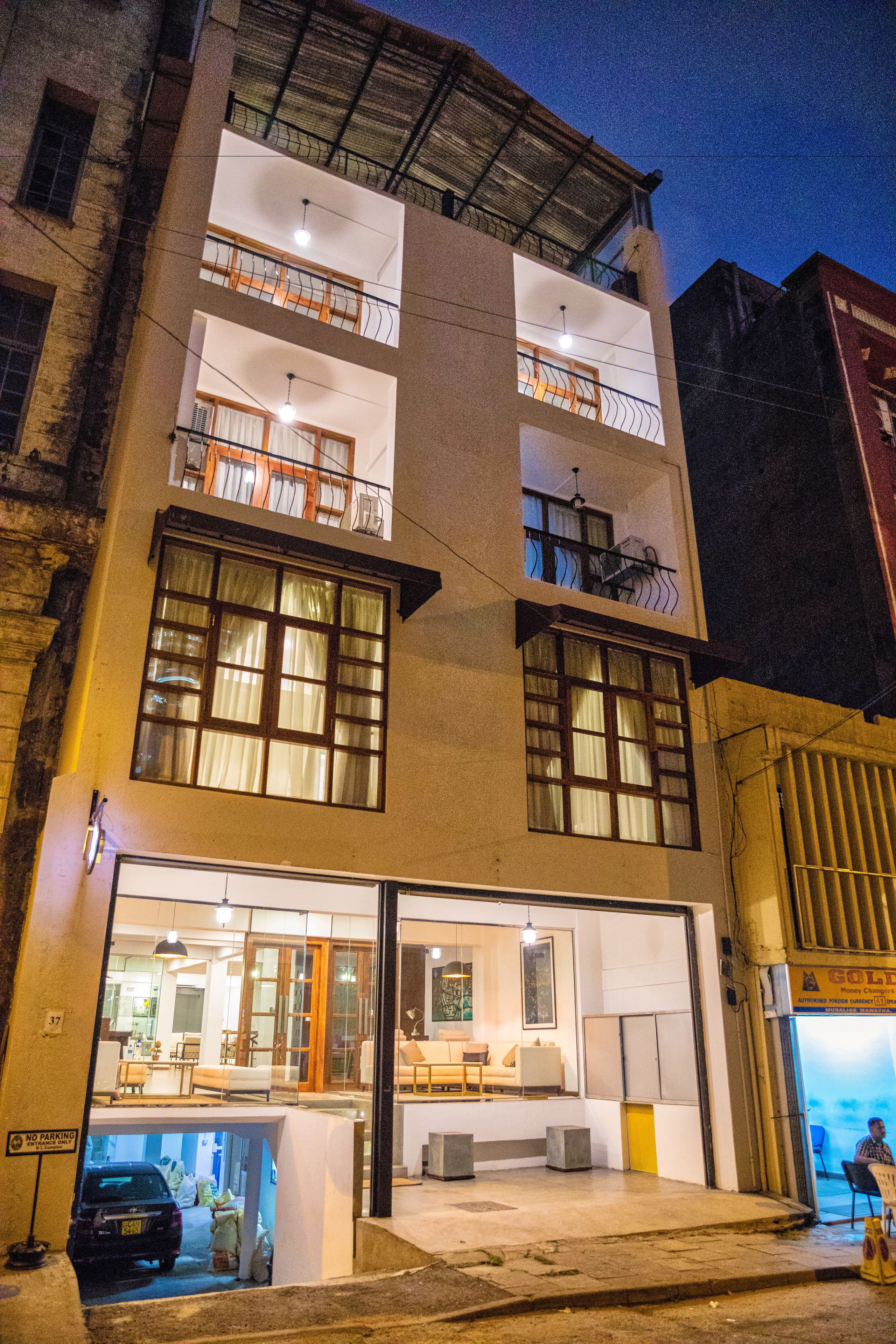 A multi-story building with a ground-floor restaurant and upper-floor balconies.