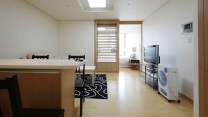 A modern living room with a dining area, a TV, and a fan. - Galleria Palace 3 (Seoul)