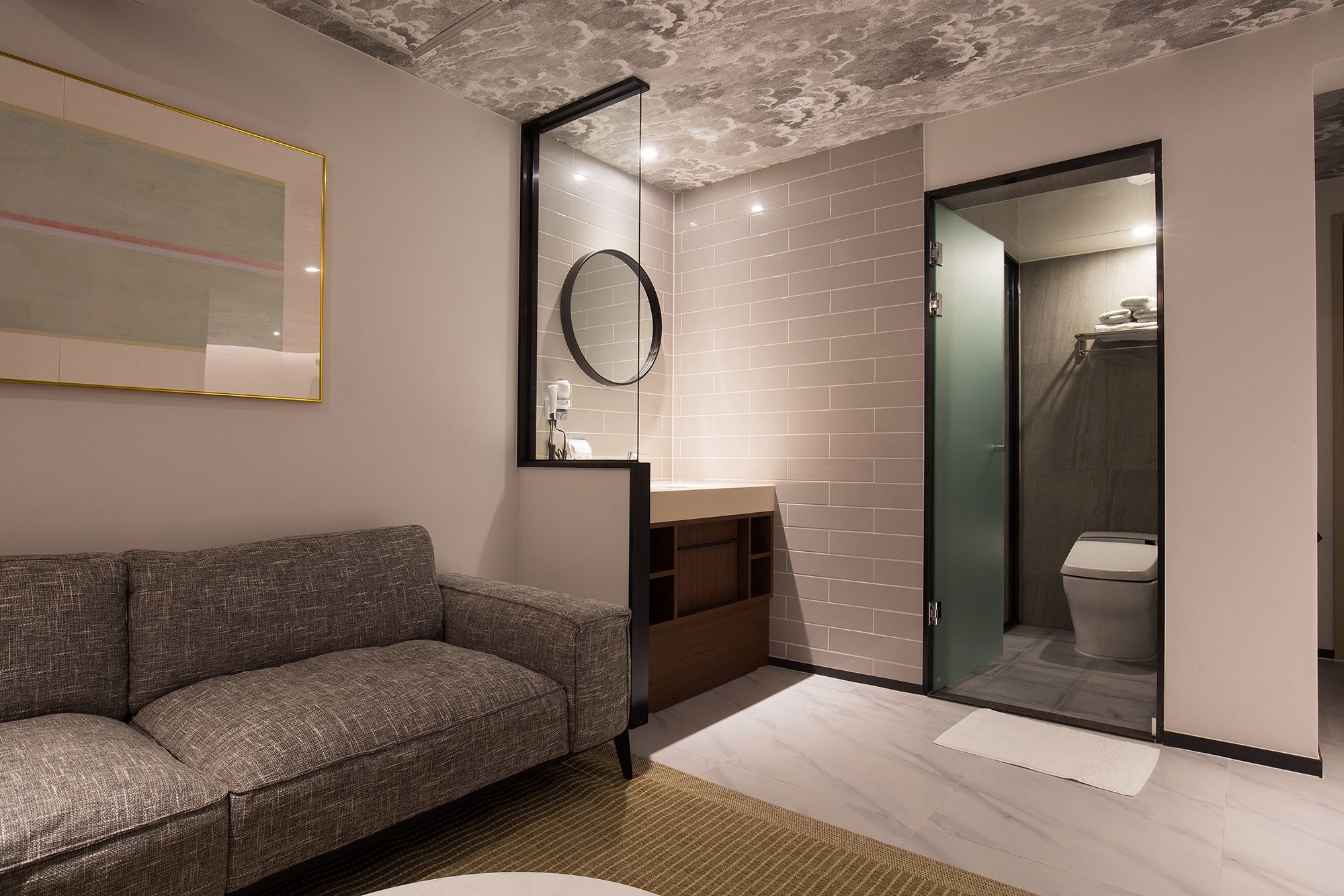 A modern bathroom with a glass shower enclosure, a built-in toilet, and a vanity with a mirror.