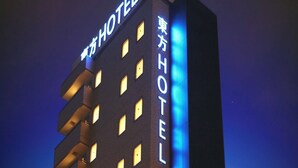 A hotel building with illuminated signage in both English and Japanese, featuring multiple floors and a modern architectural design. - Toho Hotel (Osaka)