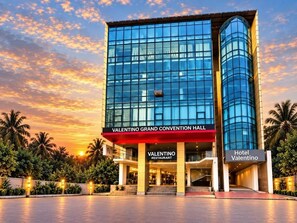 A modern hotel with a glass facade, named Valentino Grand Convention Hall, and a separate section for Valentino Restaurant. - Hotel Valentino (Noakhali)