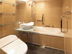 A bathroom with a white toilet, a glass sink, and a bathtub. - APA Hotel Nihombashi Bakurocho Ekikita (Tokyo)