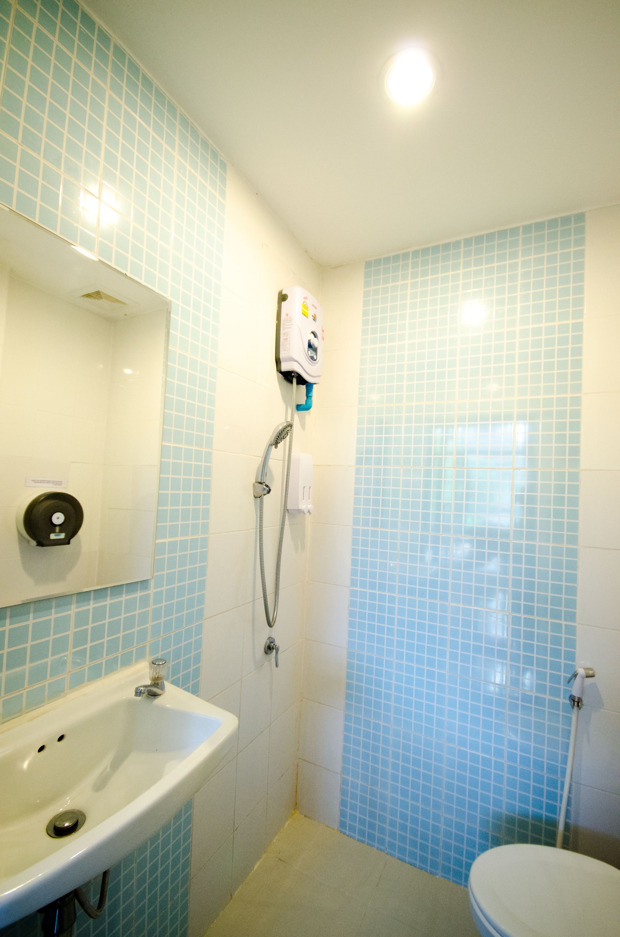 A bathroom with a sink, mirror, and toilet.