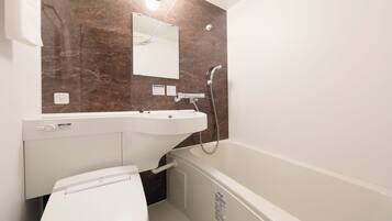 A bathroom with a white toilet, a sink, and a bathtub.