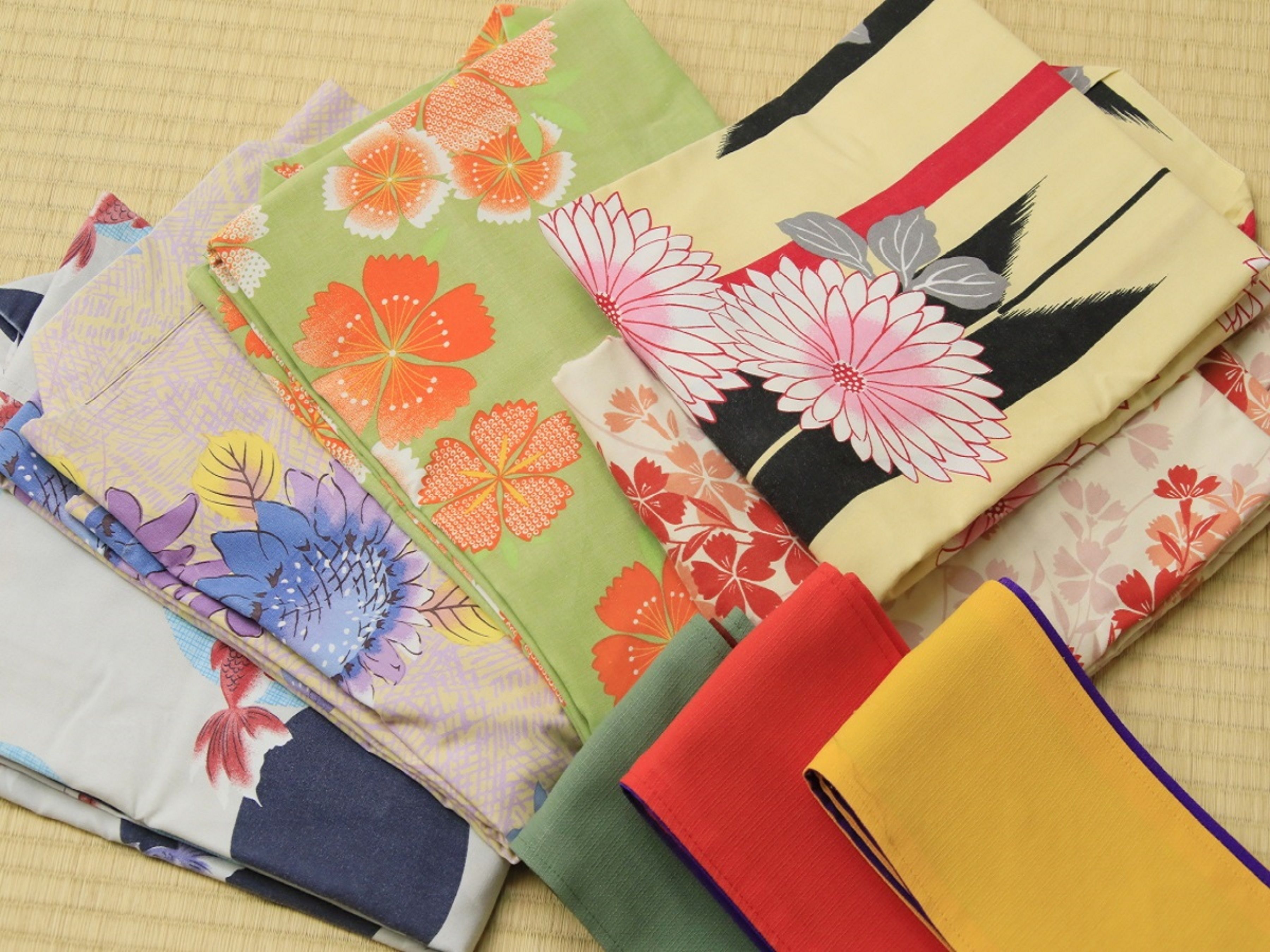 A variety of colorful fabrics with floral patterns.