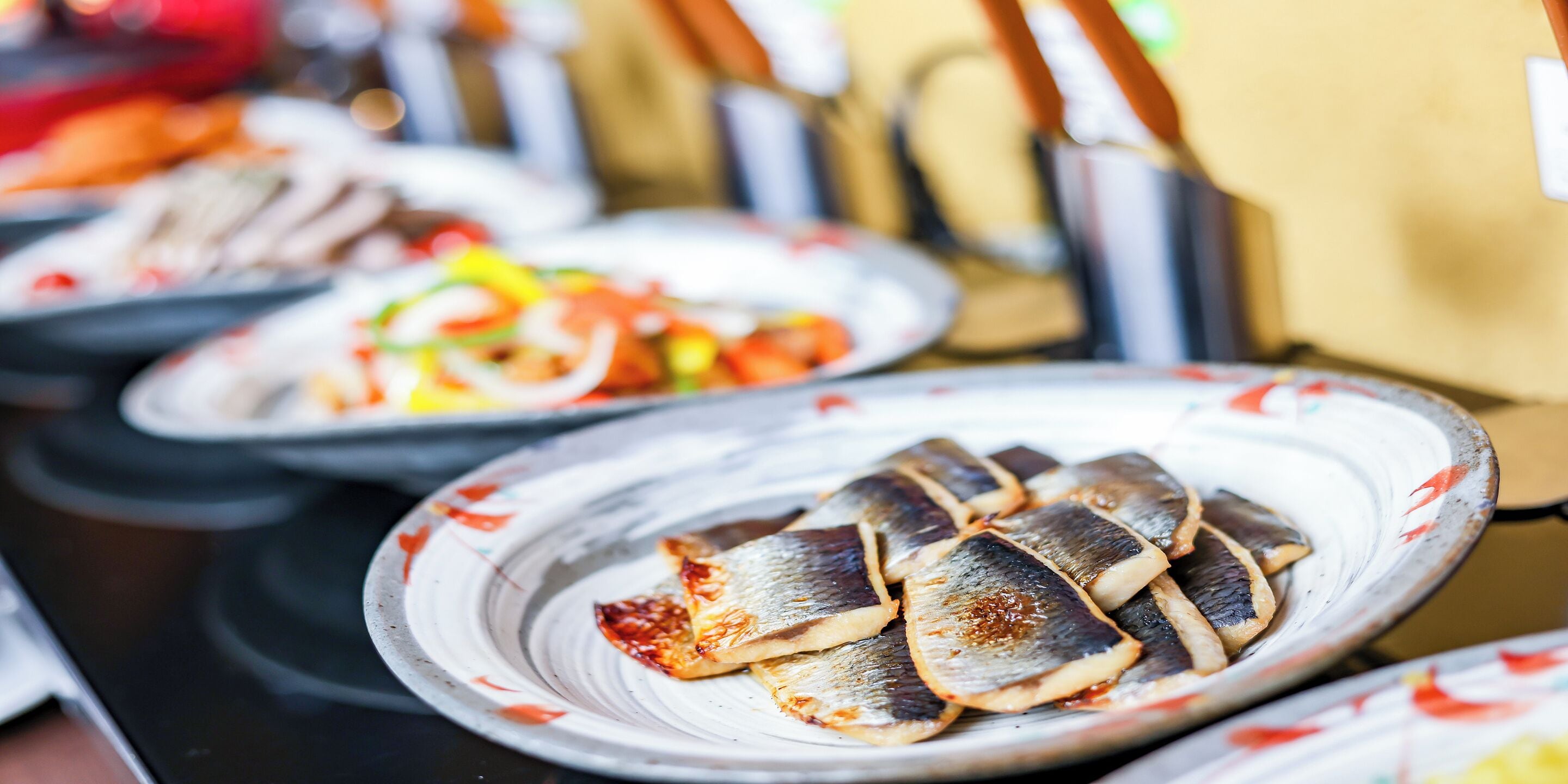A close-up of a plate with grilled fish.